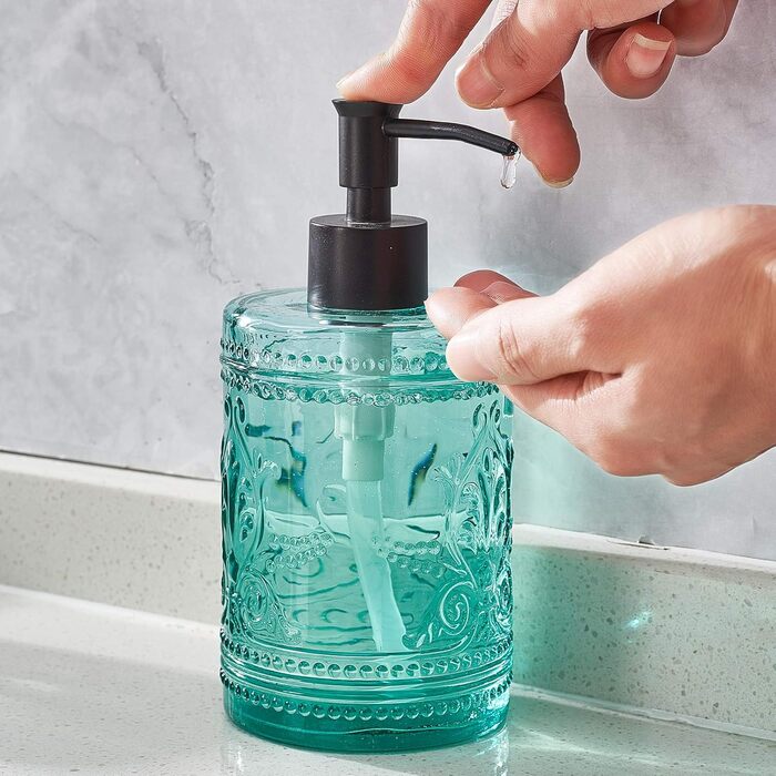 4-piece glass bathroom accessory set with decorative pressed pattern, including soap dispenser, tumbler, soap dish, and toothbrush holder, blue-green