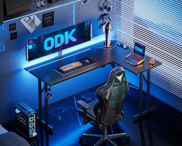 Ігровий стіл ODK L-подібний з LED та розеткою, комп'ютерний стіл з гачком для навушників, кутовий письмовий стіл для дому, карбон, чорний, 130×90 см