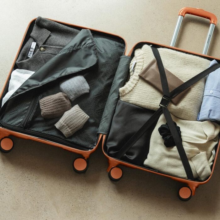 Набір валіз NUMADA Upfly T10 (4 шт.): ручна валіза 55x40x20 см, середня 60L, велика 78L, косметичка. ABS, помаранчевий колір. Міцний та надійний багажний набір.